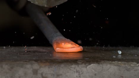 Blacksmith-at-work-on-an-anvil-shaping-some-steel-in-super-slow-motion