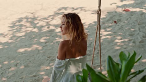 woman relaxing on a beach swing