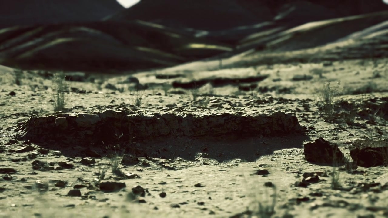 Close view of muddy terrain with reflective surface and textured elements