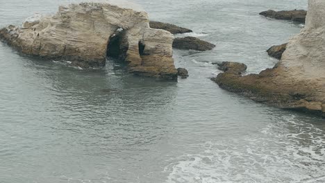 Waves-coming-in-through-Coastal-bluffs-on-overcast-day