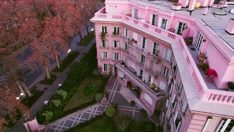 Aerial-orbiting-shot-revealing-a-beautiful-luxury-pink-building-in-downtown-Providencia
