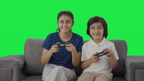 Happy-Indian-cousins-playing-video-games-Green-screen