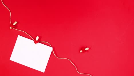 romantic paper hooked on rope for text for valentine's day on red theme. stop motion