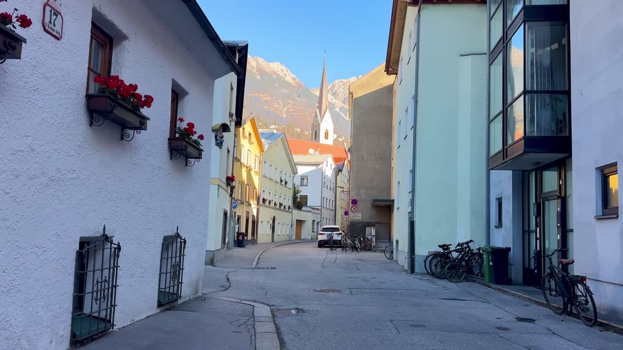 Innsbruck streets framed by snow-dusted mountain peaks.
