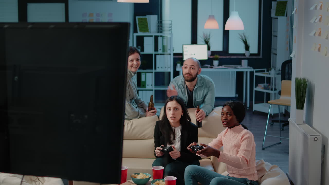Colleagues losing at video games on console after work