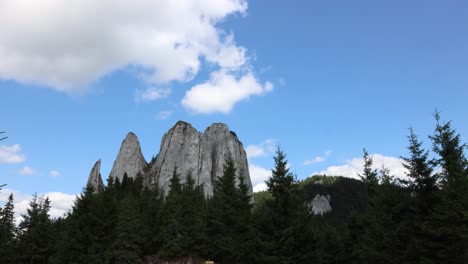 blue sky with white clouds over piatra singuratica mountain peak