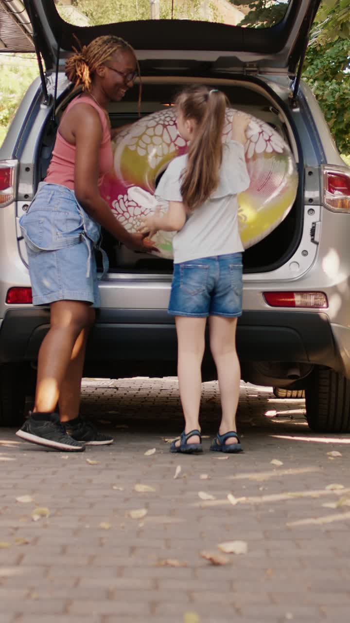 Famiglia che prepara l'auto per le vacanze estive