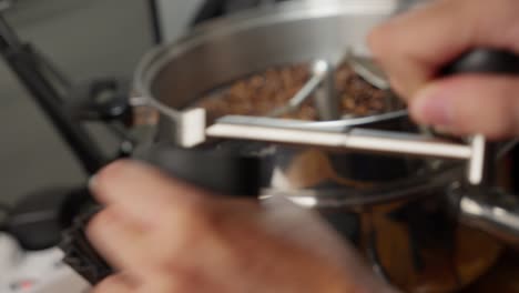 Close-up-of-a-barista-manually-grinding-coffee-beans