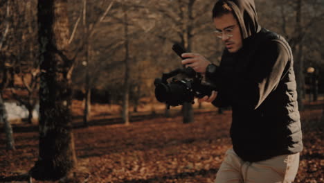 millennial content creator filming with a video camera mounted on a steadicam gimbal