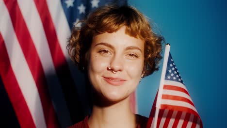 smiling woman holding american flag