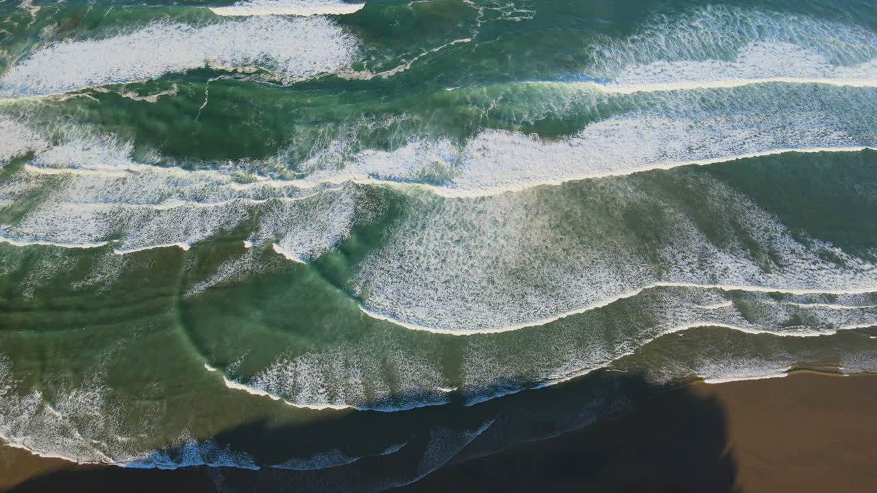 captura una vista fascinante de las olas del océano rodando y chocando contra la orilla