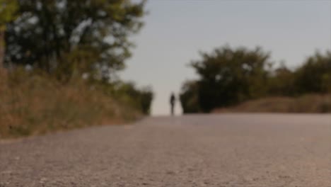 blurred cyclist riding a bicycle on an open road through nature