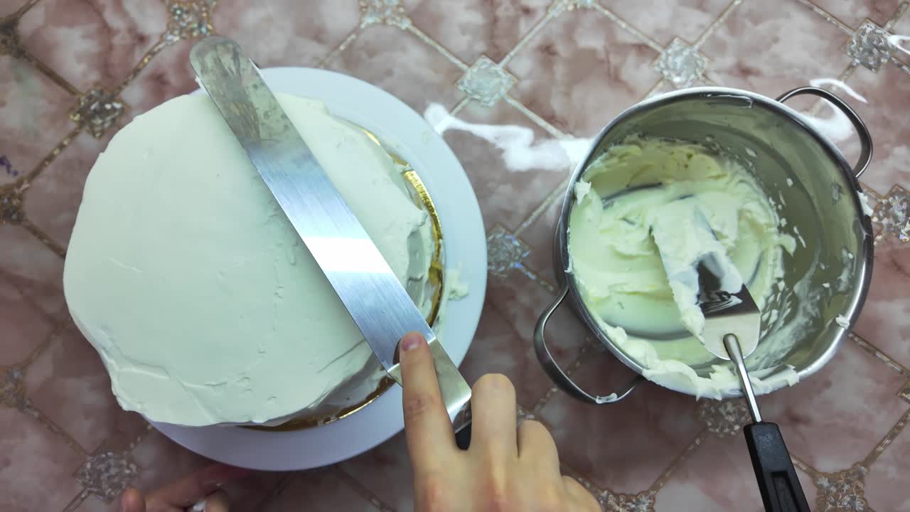 The cake is being frosted