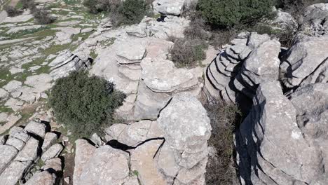 Flying-with-a-drone-through-the-natural-area-of-​​El-Torcal,-a-karst-area-located-in-Antequera-in-the-province-of-Malaga,-Spain