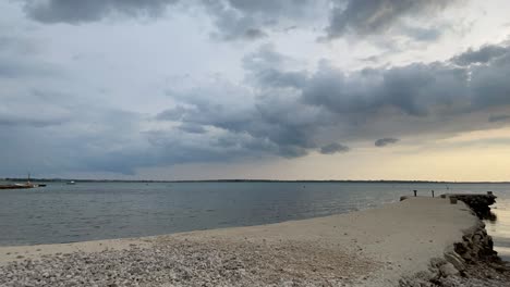 Time-lapse-of-clouds-and-waves-in-sunset-on-the-Adriatic-Sea,-Vrsi-Mulo---Zadar,-Croatia