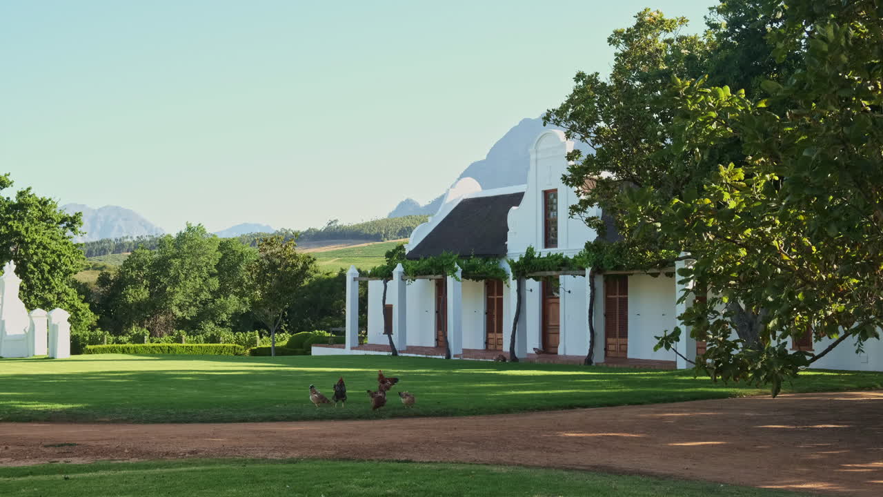 Babylonstoren Cape Dutch countryside chapel garden with chickens feeding on grass rural historic South Africa winery home