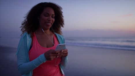 ethnic female doing walking exercise with smart phone