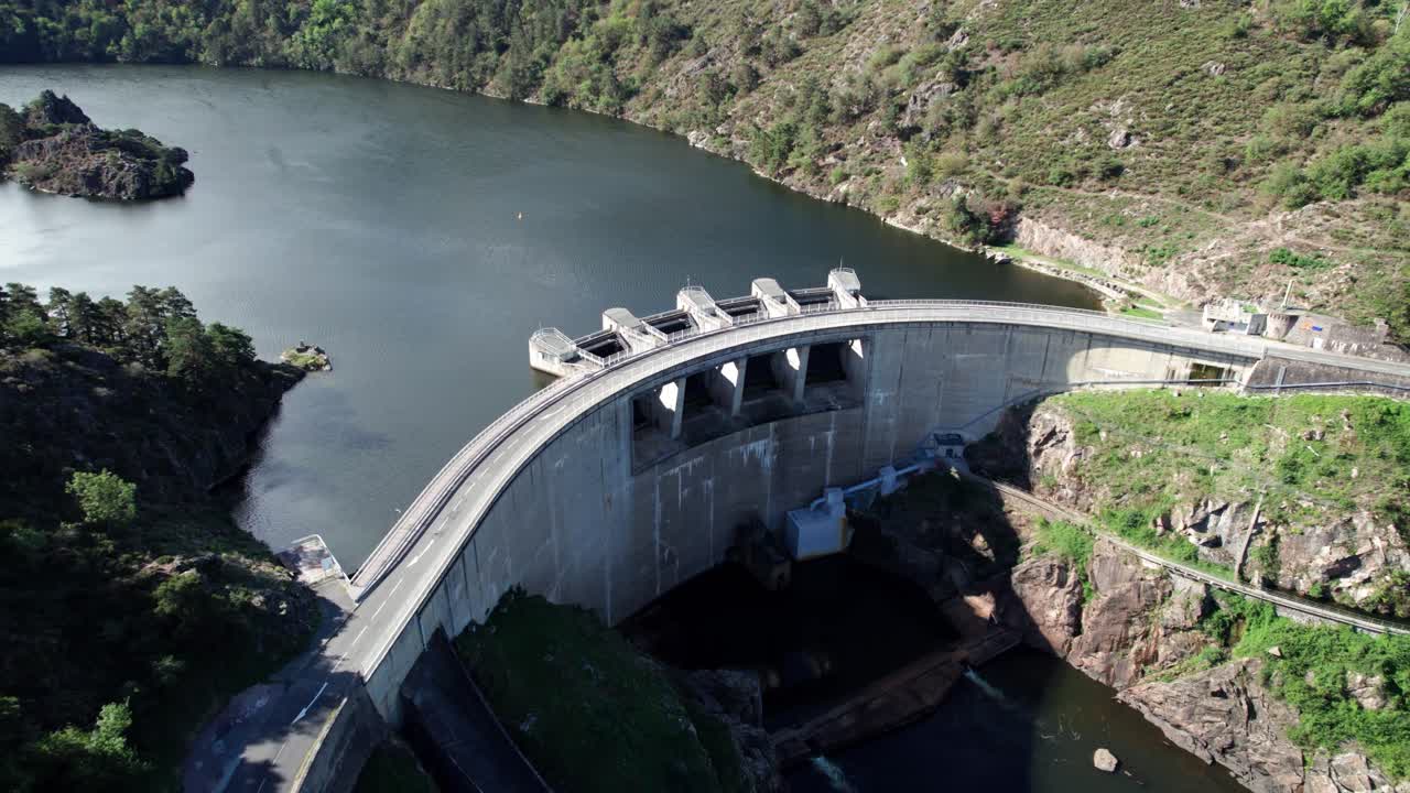 aerial shot going backward revealing hte Grangent Dam and the landscape around on a sunny day near Saint Etienne city in Loire departement, Auvergne Rhone Alpes region, France