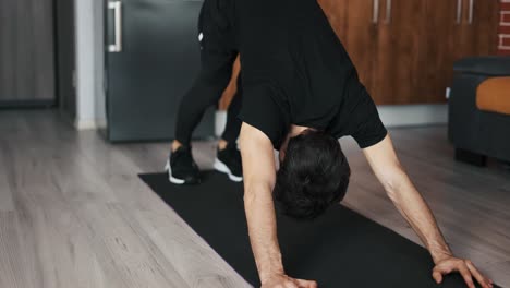 man exercising stretching back yoga pose on the mat