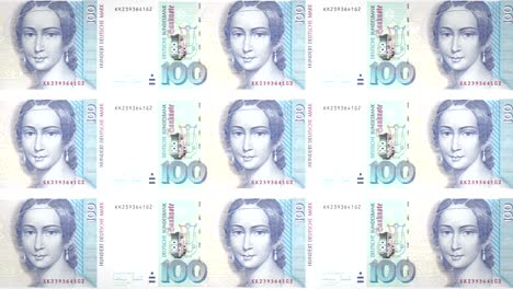 banknotes of one hundred german marks or deutschmarks of the bank of the old west germany or federal republic of germany rolling on screen, coins of the world, cash money, loop