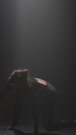 contemporary dance performance in a dark studio