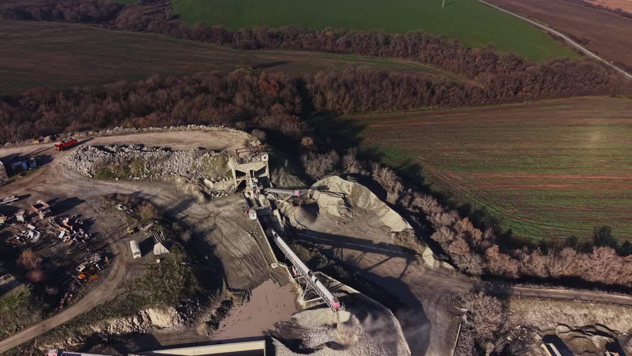 Quarry site shows machinery and land in use for mining operations