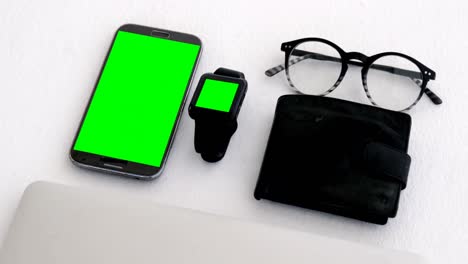 Electronic-gadgets,-wallet-and-spectacles-on-white-background-4k