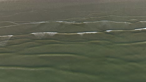 a top-down aerial shot of the seashore near the port of ijmuden