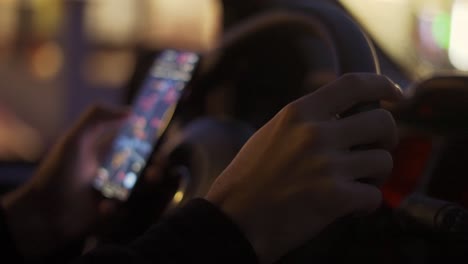 A-man-looking-map-on-his-mobile-phone-during-driving-at-night