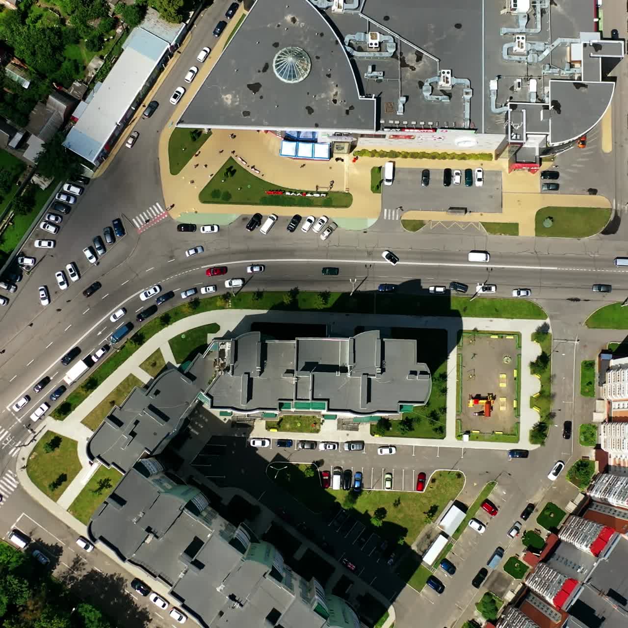 Modern cityscape. Residential streets and cars between apartment building rooftops. Traffic and parking places in the city. Top view.