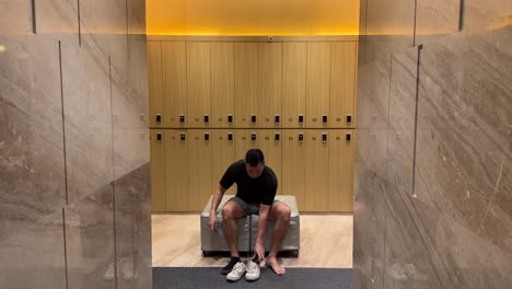 Rich-Asian-Millennial-Man-Putting-on-Shoes-in-a-Luxurious-Changing-Room