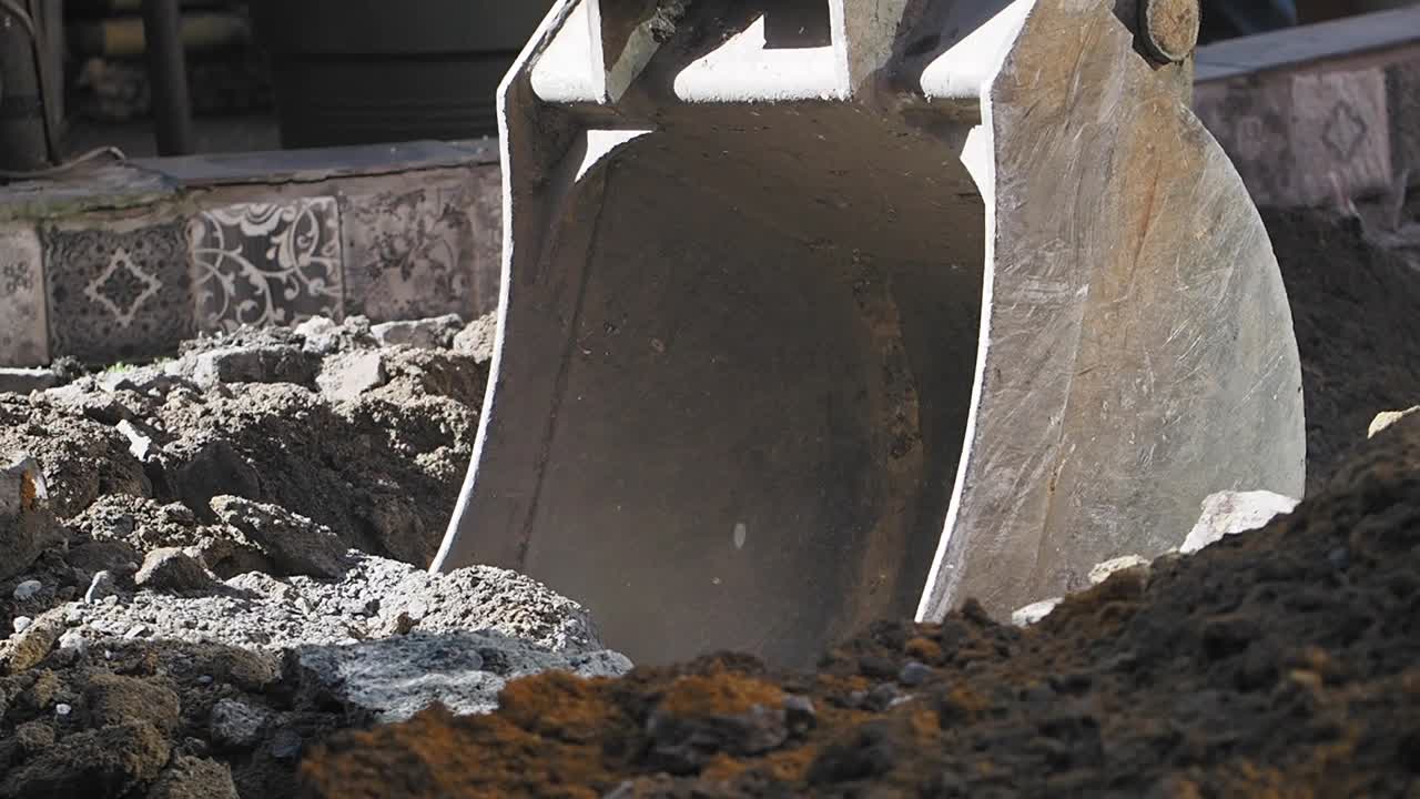 Excavator bucket digging dirt
