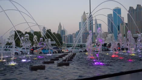 dubai fountain at dusk with cityscape