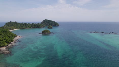 aerial view of turquoise waters and lush greenery surrounding coiba island and isla ranchería in panama