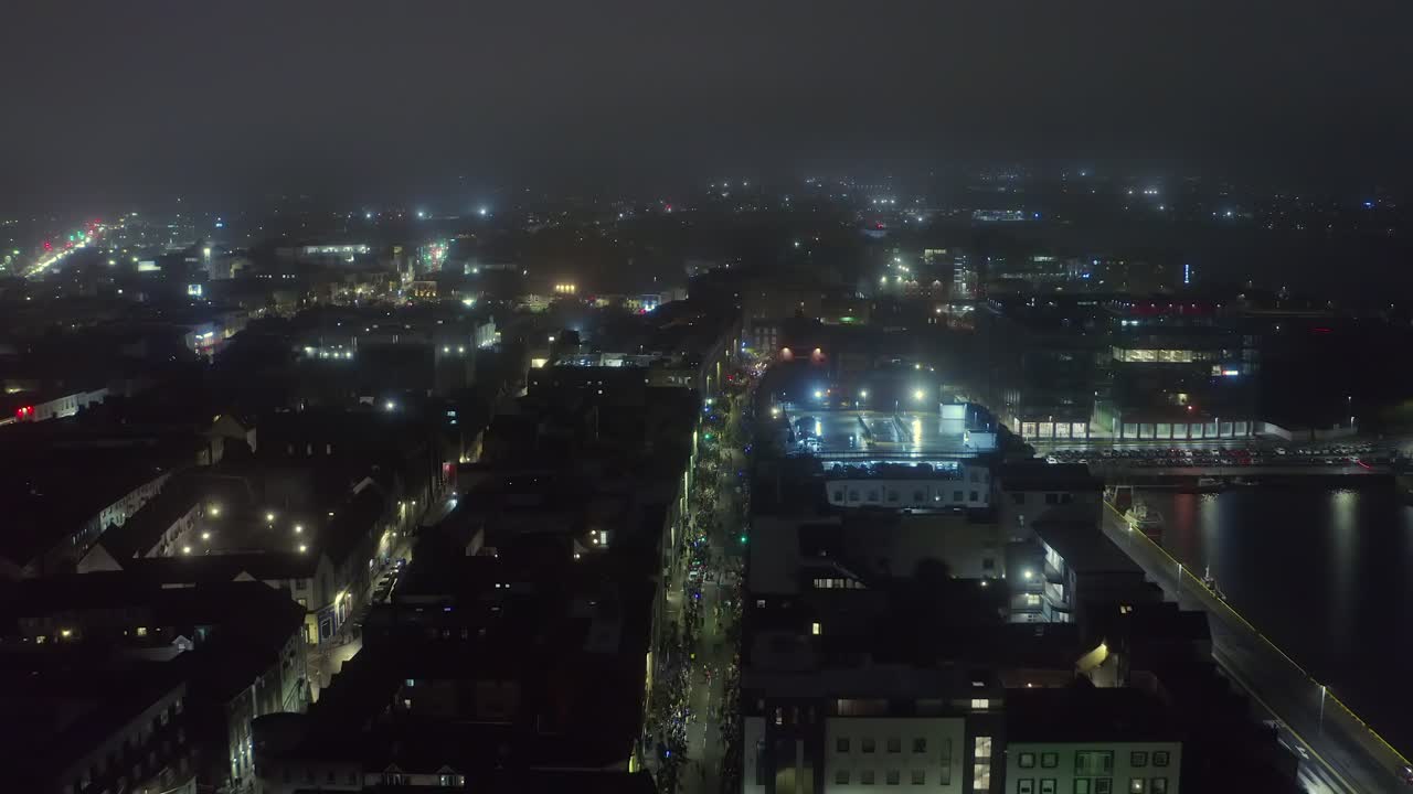 Aerial pullback of Galway’s Halloween parade on a misty, spooky night