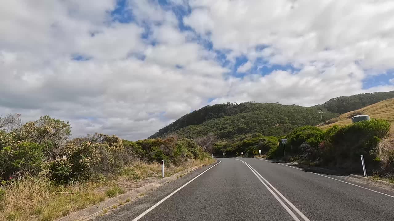 A 15-second journey showcasing the picturesque Great Ocean Road with lush landscapes, coastal views, and dynamic skies