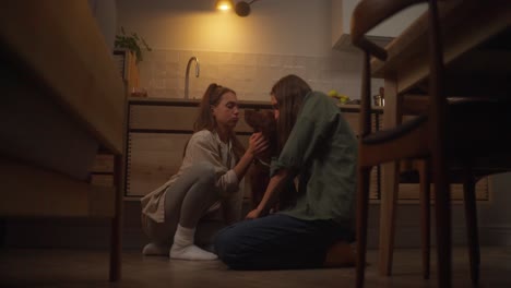 couple interacting with their dog in a cozy kitchen