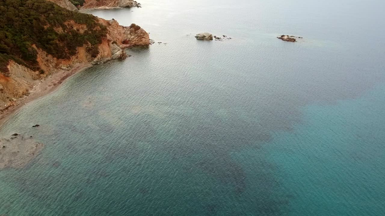 Sardaignan shore and sea diving view from a drone by sunset