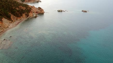 sardaignan shore and sea diving view from a drone by sunset