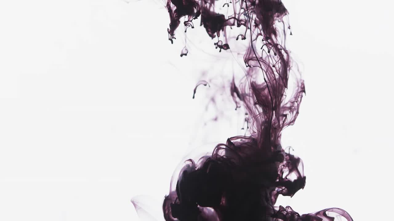Slow motion video of purple watercolor ink mixing in water against grey background