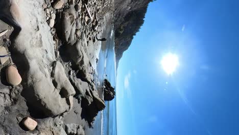 A-photographer-walks-the-beach-of-Arago