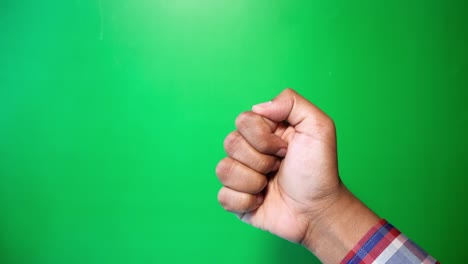 close up of man's hand showing thumb up sign