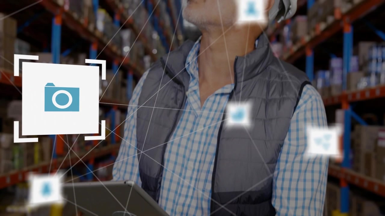 Magazziniere che tocca lo schermo del tablet e mostra icone dell'interfaccia utente mentre scansiona gli scaffali, indossando un cappello.