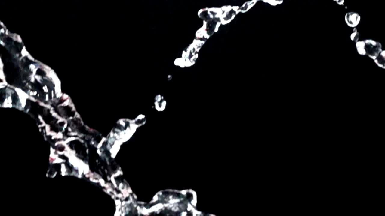 Water on a black background. Slow motion
