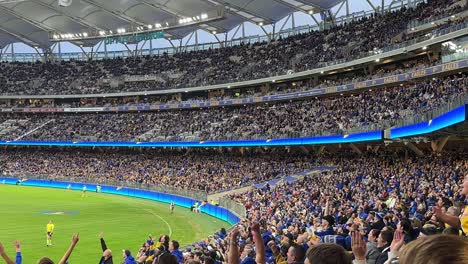 australian rules football game at optus stadium with west coast eagles fans