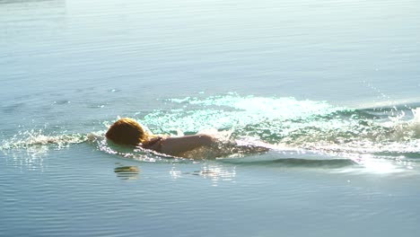 woman swimming in the water at beach 4k