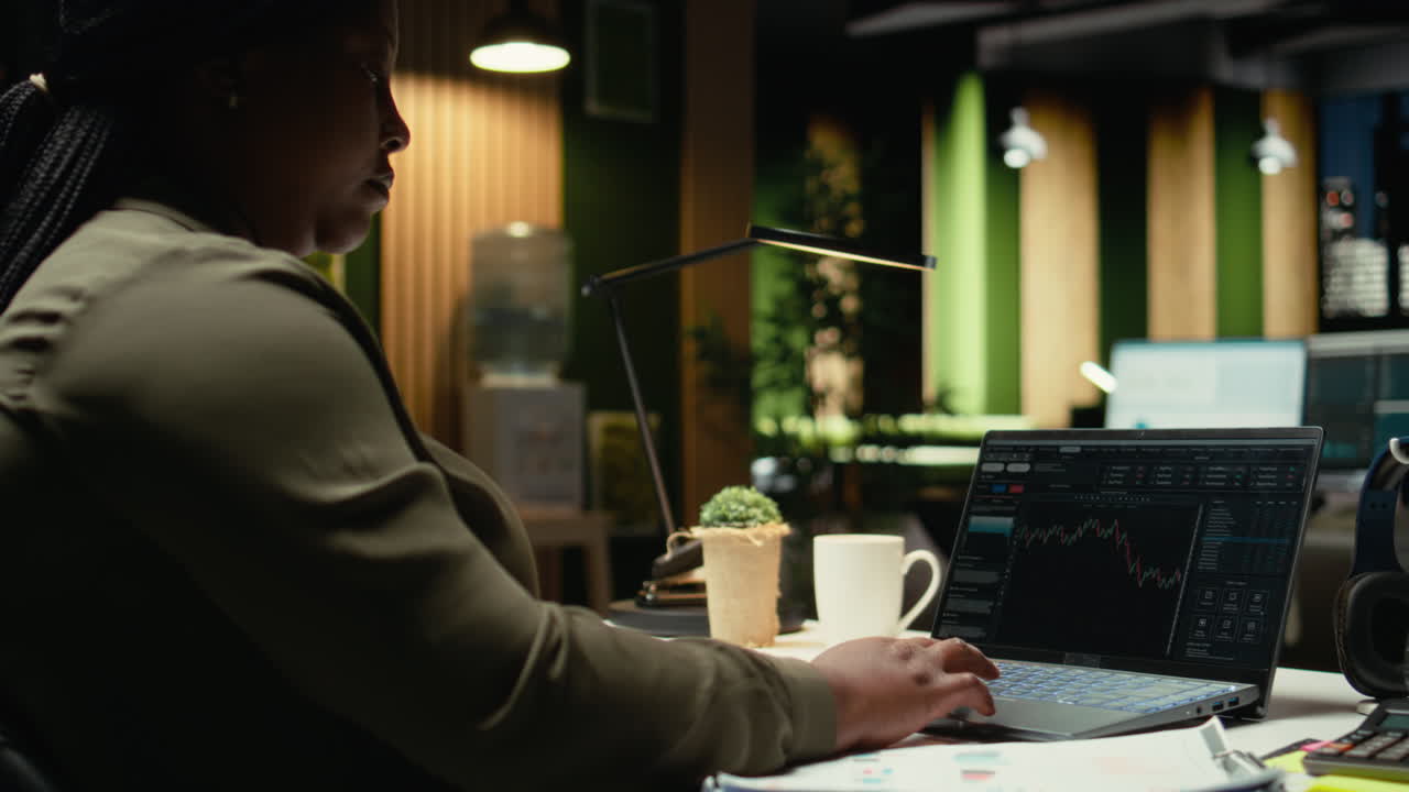 African american staff monitoring live stock trends for cryptocurrency market