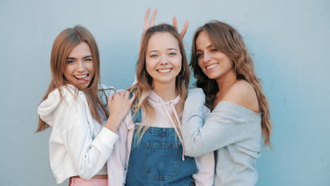 three happy friends posing outdoors