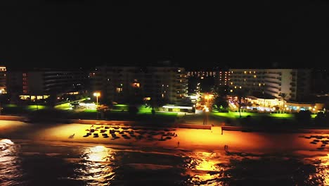 drone tracking shot of empty beach resort at nighttime, in mallorca, spain