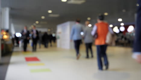 blurred people walking in a hallway